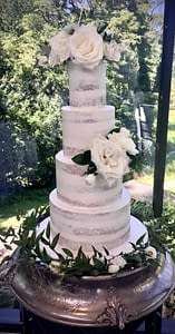 semi naked wedding cake with fresh roses