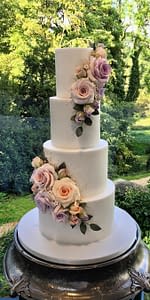 wedding cake with pastel coloured flowers