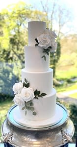classic white wedding cake with sprays of sugar flowers