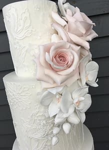 white wedding cake with dress detail close