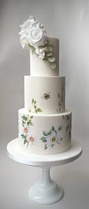 wedding cake pained with botanical flowers