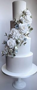 wedding cake with cascade of blue and white flowers