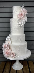 white wedding cake with dress detail