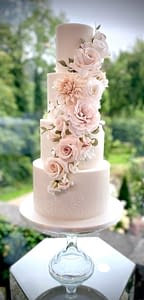 wedding cake with cascade of blush flowers