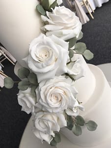 white wedding cake with white roses